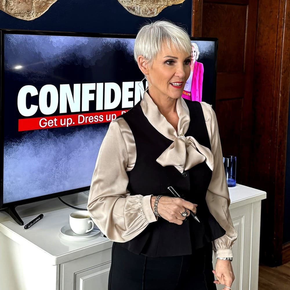 Linda Paige beside a screen reading Confidence: get up, dress up