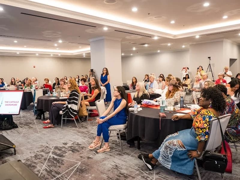 A room of women at round tables during one of Linda’s group sessions