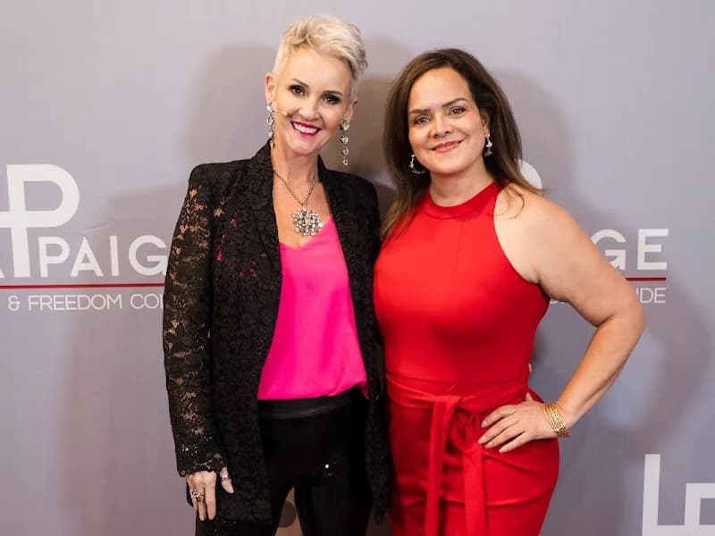 Linda with a client in front of the LindaPaige backdrop