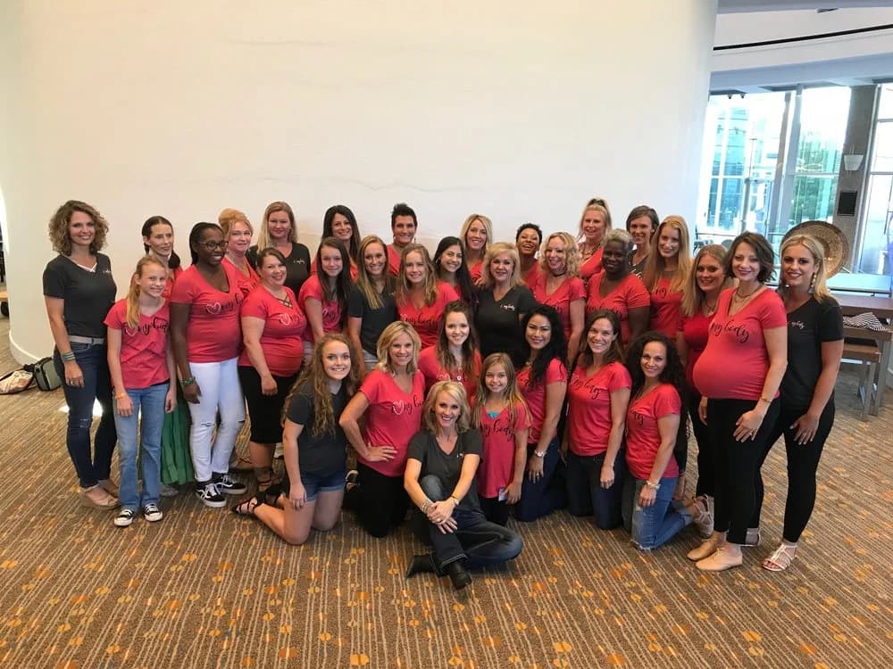 A group of women wearing their I Love My Body shirts together