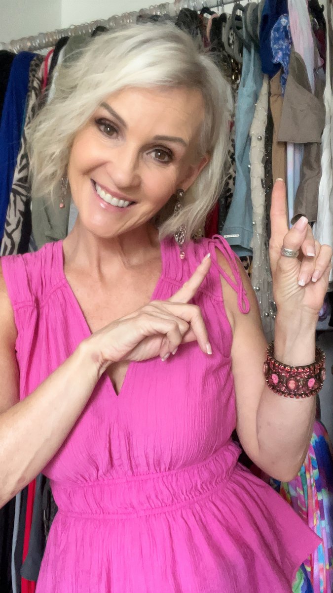 Linda Paige in a pink dress in her closet