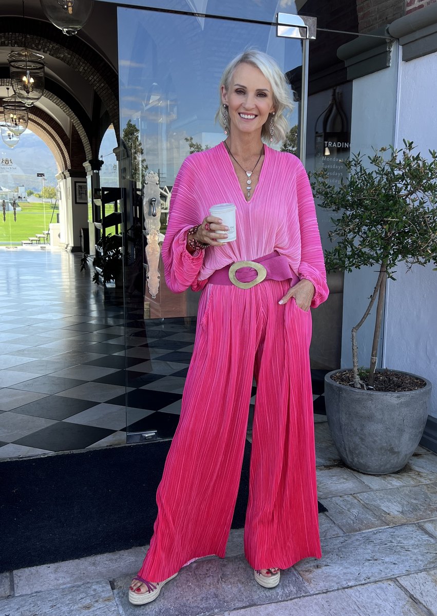 Linda Paige in a pink pleated jumpsuit